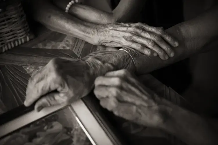 Isabelita Vinuya, Belen Alarcon Culala and Maria Lalu Quilantang clasp hands. The three women were repeatedly raped as children by Japanese imperial soldiers in their village of Mapaniqui. Image by Cheryl Diaz Meyer. Philippines, 2019.
