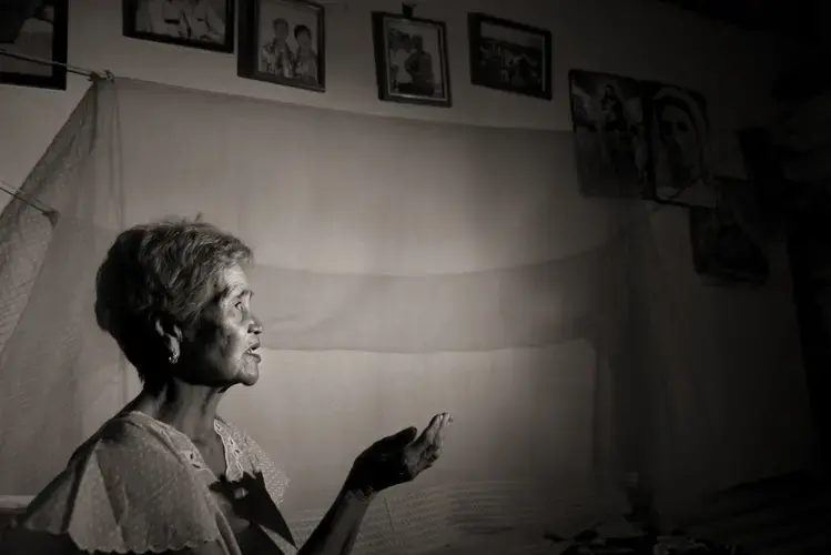 Isabelita Vinuya prays nightly for peace and forgiveness. She was 12 years old when a mass rape took place in her village of Mapaniqui. Image by Cheryl Diaz Meyer. Philippines, 2019.