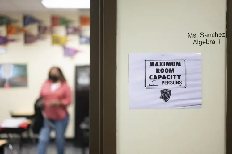 Kelly Hawkins, an English teacher, stands in her classroom at the charter school Lake Charles College Prep. Image by Katie Sikora. United States, 2020.<br />
