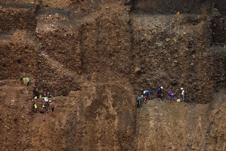 A team of small-scale miners perch precariously on a mine cliffside, using jack hammers to dig for jade on July 15, 2020. Image by Hkun Lat / Frontier. Myanmar, 2020.