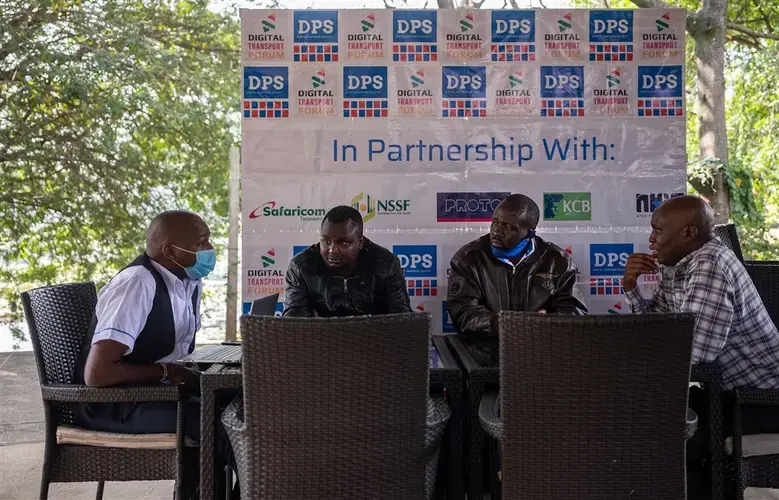 Rhayan Kanyandong, left, Patrick Ombongiga, Wycliffe Alutalala and David Mutera meet daily at a Nairobi café to discuss their work with the Digital Partners Society, a community organization that represents drivers and vehicle owners on issues related to regulating the industry. Image by Nichole Sobecki/NBC News. Kenya, 2020.<br />