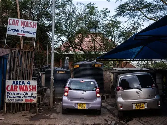 An Uber driver in Nairobi, Kenya, gets ready last month to pull out of the car wash where he parks his vehicle each night and begin his work day. Image by Nichole Sobecki/NBC News. Kenya, 2020.<br />