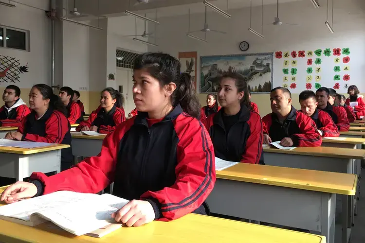 Residents at the Kashgar city vocational educational training centre attend a Chinese lesson during a government organised visit in Kashgar, Xinjiang Uighur Autonomous Region. Image by Ben Blanchard/Reuters. China, January 4, 2019.