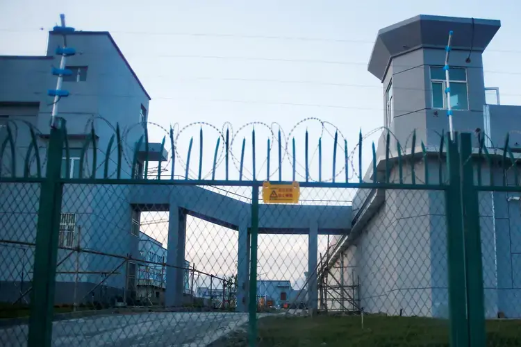 A perimeter fence at the entrance to what is officially known as a vocational skills education centre in Dabancheng in Xinjiang Uighur Autonomous Region. Image by Thomas Peter/Reuters. China, September 4, 2018.