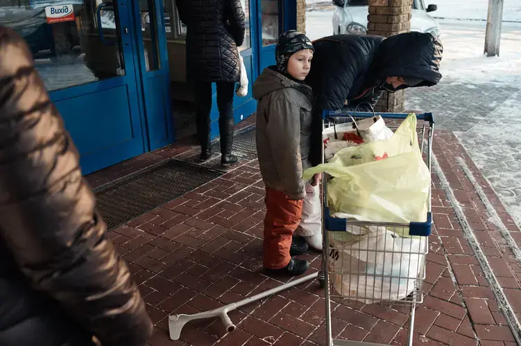 Alla, with her son, after receiving groceries paid for by Svitanok in 2016. HIV-positive, she fled her home just outside of Donetsk amid fighting and is now living with her son in Kramatorsk. Image by Misha Friedman. Ukraine, 2016.