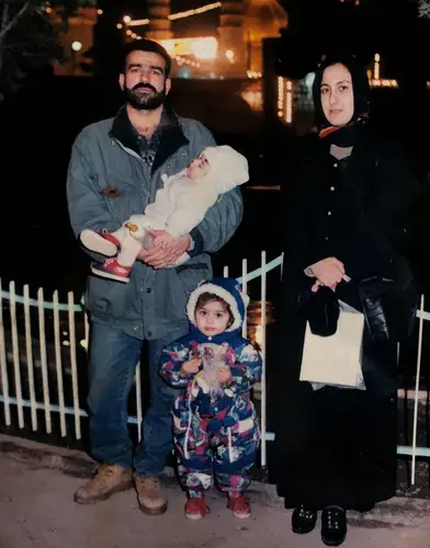 Mohammad Sibte, far left, holds his daughter Hawra Ahmad and poses for a photo with his wife Lamiya Mahdi, far right, and daughter Zahra Ahmad, front center. Image courtesy of Ahmad family.