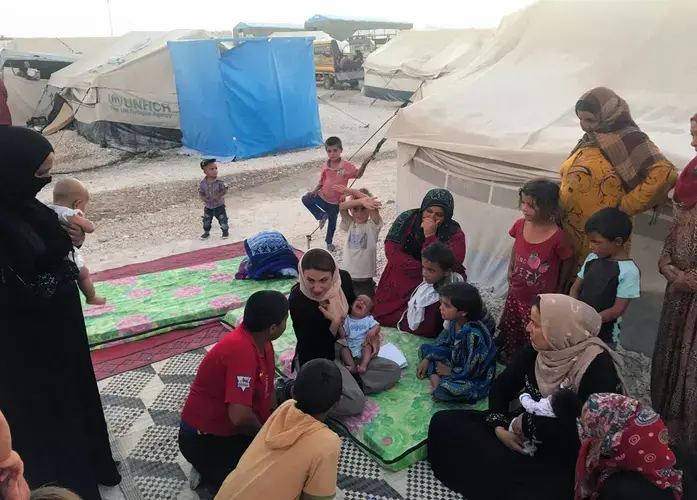 Gayle Tzemach Lemmon (center) talks to Syrians displaced by fighting. Image by Jon Gerberg/PBS NewsHour. Syria, 2017.