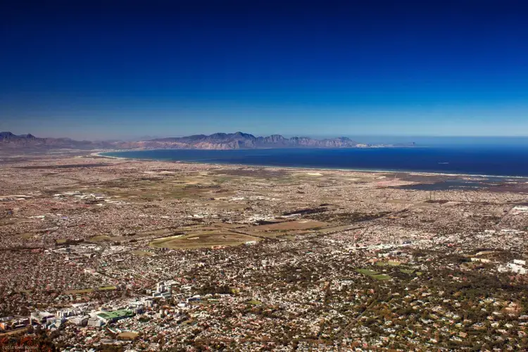 Sprawling east from Table Mountain, the Cape Flats are home to many of the city black and poorer residents. In the foreground is the wealthier Newlands district. Image by Brett Walton of Circle of Blue. South Africa, 2018.