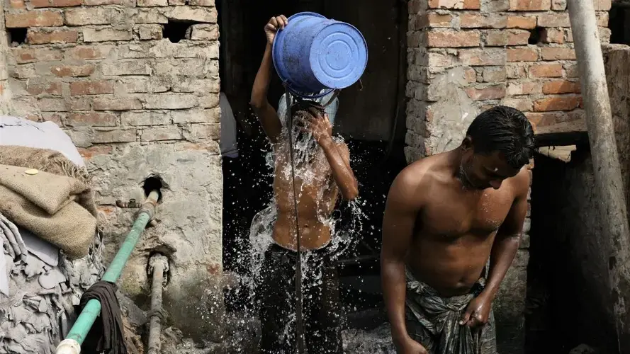 Workers rinse off after their jobs at a tannery. Image by Justin Kenny. Bangladesh, 2016.