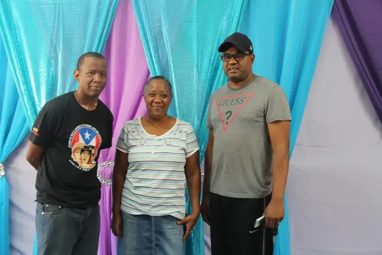 Alexis Correa Allende, Evelyn Allende and Guillermo Carmona in Parcelas Suárez. Image by Kari Lydersen. Puerto Rico, 2019.