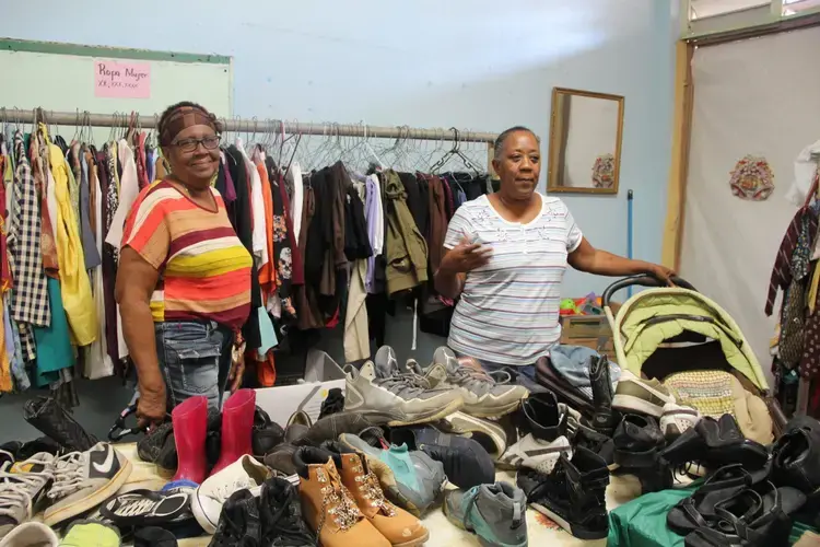 Community leaders distribute free clothing and more at the closed school transformed into a community center in Parcelas Suárez. Image by Kari Lydersen. Puerto Rico, 2019.