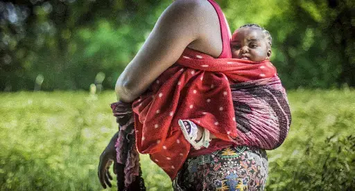 Glory and her 8-month-old daughter, Mary, stop for a portrait as they make the journey through the countryside back to their ANKER center in Bavaria, Germany. Image by Angelica Ekeke. Germany, 2019.