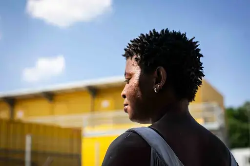 Sandra, a Nigerian refugee and two-year resident of the Ingolstadt ANKER center, stands in front of the center in Bavaria, Germany. Image by Angelica Ekeke. Germany, 2019.