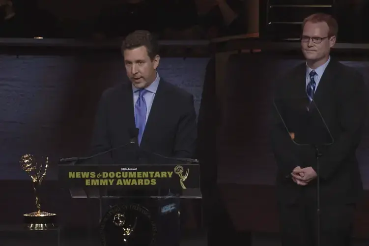 William Brangham (front) and Jason Kane (back) deliver the team's acceptance speech at the 38th Annual News and Documentary Emmy Awards.