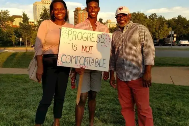 The Washingtons, Theo, Denise and their son, Teddy at a rally supporting racial equity in Clayton, Mo. Courtesy of the Washington family. United States, 2019.