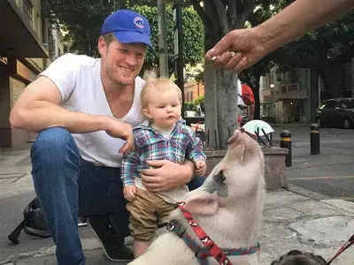 Father and son meet up with the pet pig often seen in their neighborhood in Mexico City. Image courtesy Erik Vance. Mexico, 2017.