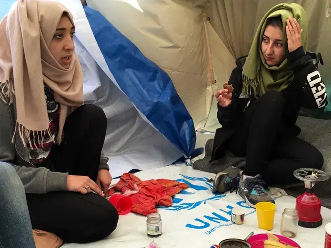 Venus and Wesam Daas, right, at Idomeni refugee camp on the Greece-Macedonia border. Image by Jeanne Carstensen. Greece, 2016.