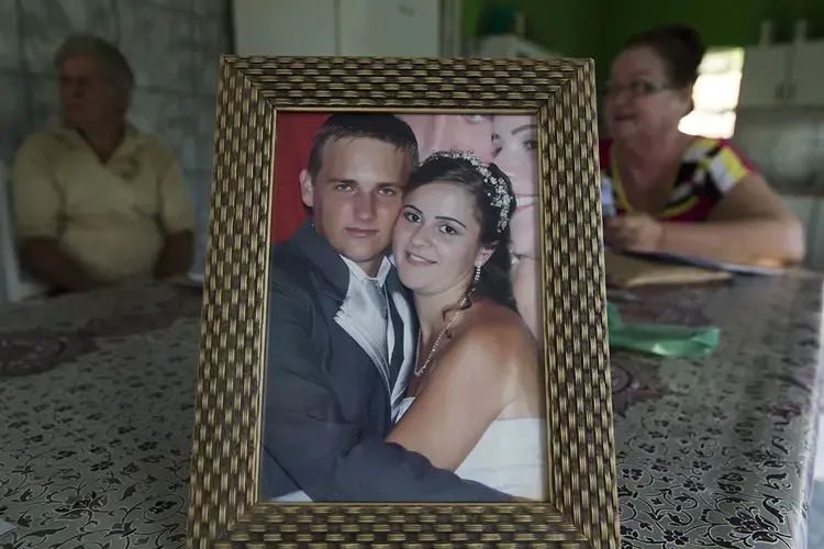 Virlei Braun is shown with his wife, Franciele Casagrande Strehlow, in their wedding photo on display at his parent's home in São João Pequeno. Braun was a 30-year-old father of a toddler son when he died of yellow fever. Image by Mark Hoffman. Brazil, 2017.