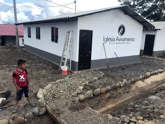 A boy stands outside the community church in the FARC transition zone Mariana Paez near Mesetas, Colombia. The church was built in May 2018 by Avivamiento, a Bogotá-based evangelical church. Image by Julia Friedmann. Colombia, 2018.