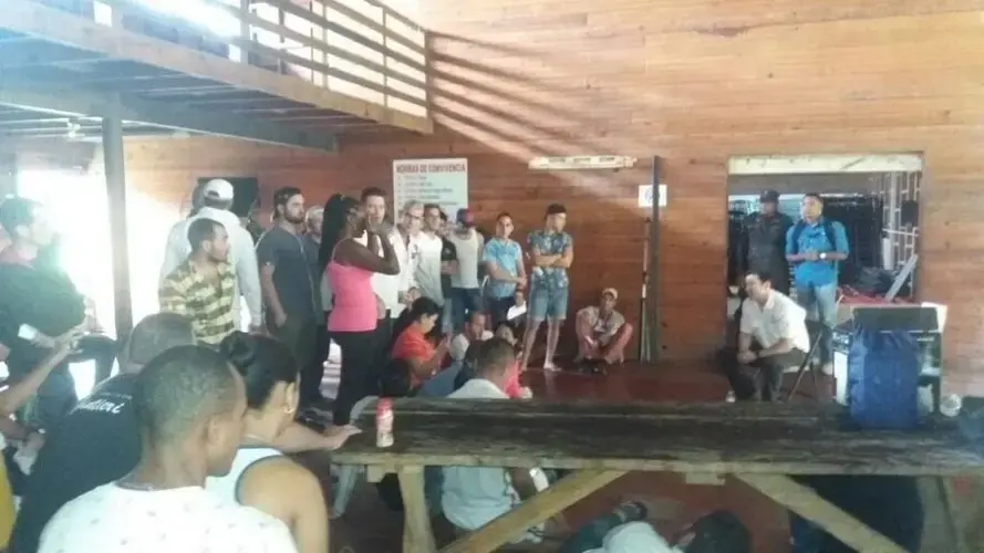 Deputy Minister of Public Security Jonathan del Rosario talks to Cuban migrants at a temporary shelter in Gualaca, Panama. 