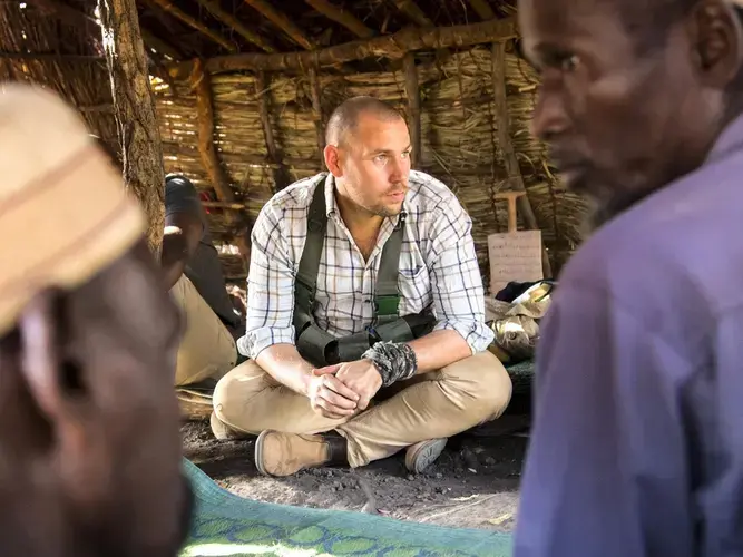 Towards the end of the meeting, park manager David Simpson, a 30-year-old Brit originally from North Yorkshire, tells them: 'You decide on the number of people who want to go. If necessary we can send a team ahead of you to alert the village ahead of your return.” Chinko's team have been monitoring developments in their village to gauge the security situation. Image by Jack Losh. Central African Republic, 2018.