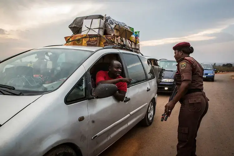 Sarah Dung inspects a vehicle at a checkpoint in Barkin Ladi on Oct. 24. Image by Jane Hahn. Nigeria, 2018.