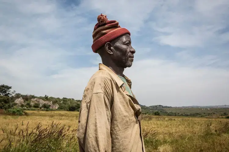 Farmer Bulus Dalyop, 58, stands in a field of fonio, a West African grain, outside Makoli Village in Barkin Ladi on Oct. 23. Image by Jane Hahn. Nigeria, 2018.