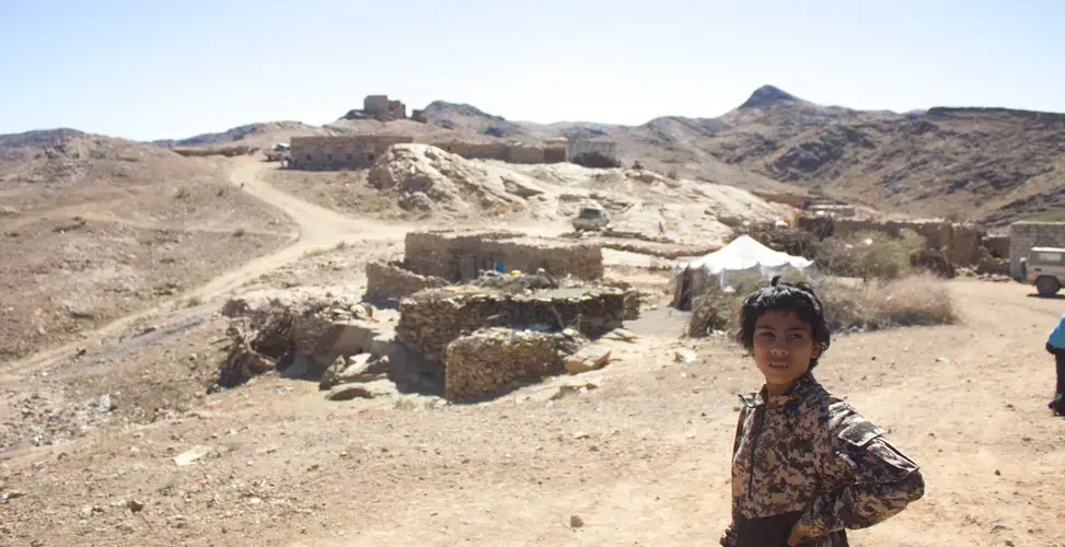 A boy stands in the village of al Ghayil in Yemen where U.S. Navy SEALs, attack helicopters, and drones launched an operation on January 29. Image by Iona Craig. Yemen, 2017. 