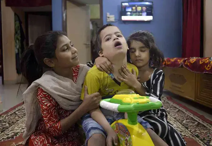 Umair, 12, with his sister Areeba (right) and cousin Sidrah. Image by Rohit Jain. India, 2020.