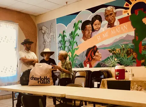 Sister Beatrice Donnellan speaks with a pair of El Pasoans donating clothes. Image by Lily Moore-Eissenberg. United States, 2019.