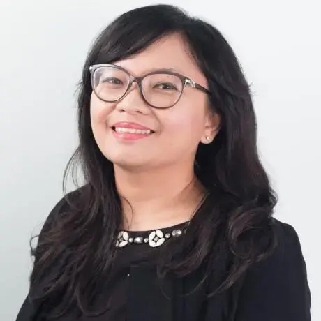 A person with glasses and a black work shirt.