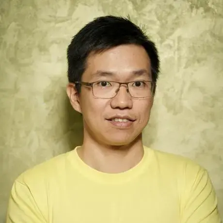 A person with a yellow shirt. The background is yellow.