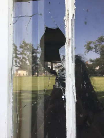 evidence of wind damage on a house window