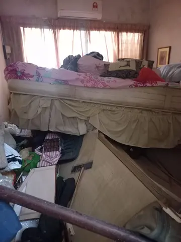 cluttered bedroom full of debris after flood