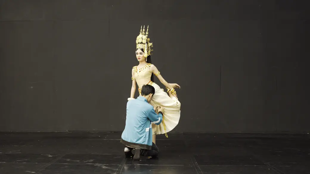 Chhan Chamrouen adjusts the pleats of Saly Sreymeas’ skirt. Image by Ingrid Olivia Norrmén-Smith. Cambodia, 2019.