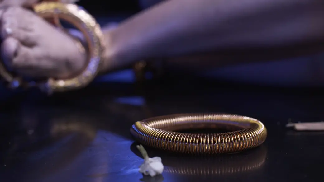 Saly Sreymeas removes the last bangle from her ankle. Image by Ingrid Olivia Norrmén-Smith. Cambodia, 2019.