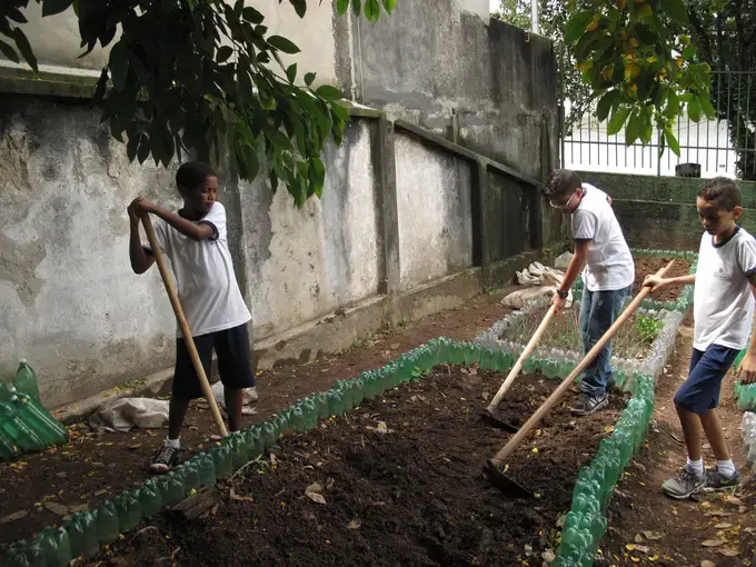 Students at the Leão Machado school dig plots before mixing in compost with the soil. Rhitu Chatterjee. Brazil, 2015. 