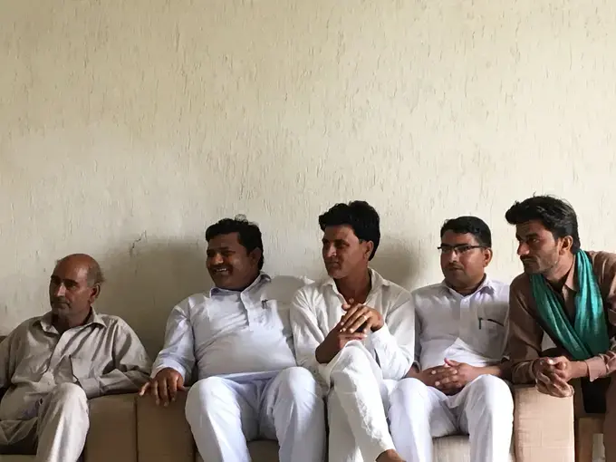 Elders from the Bishnoi, a Hindu sect of environmentalists, gather to speak about their work to conserve wildlife and plants in the region. Image by Mark Schulte. India, 2018.