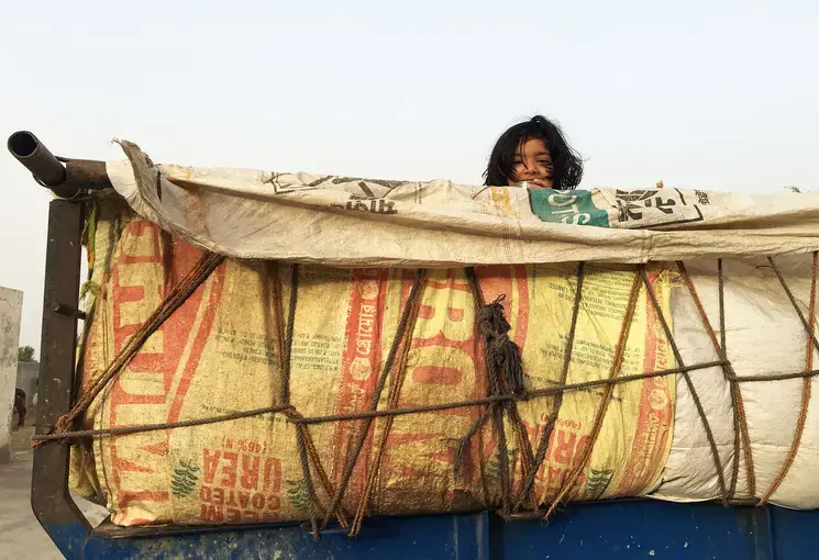 The daughter of a prosperous local farmer hides out in the mustard seed harvest. Image by Mark Schulte. India, 2018.