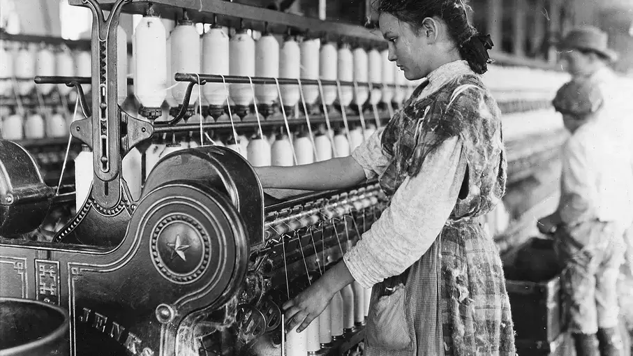  A young girl works the spinning machines, Lewis Hine, Cherryville, NC, 1908.