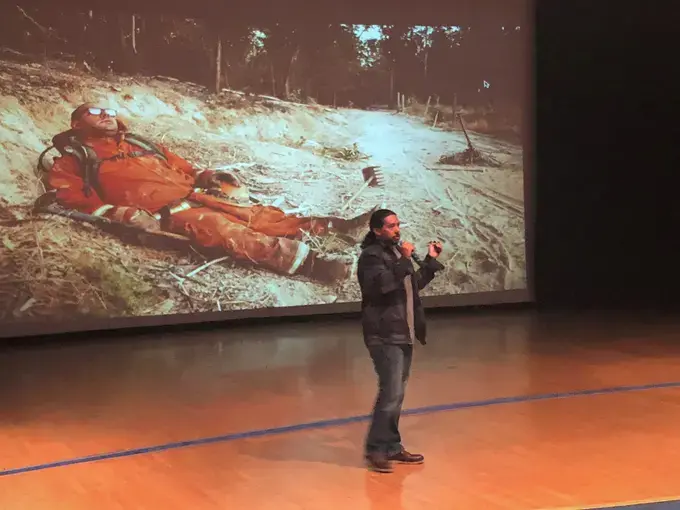 Brian Frank presents his reporting on firefighting prison labor camps at Kenwood Academy on Chicago's south side. Image by Hannah Berk. United States, 2018.