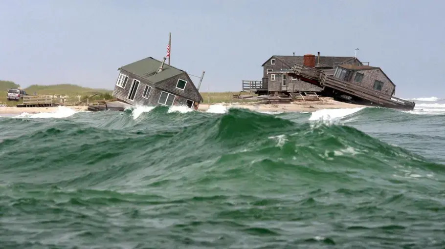 Two of five beach houses on the southern tip of Nauset Beach in Chatham were knocked off their foundations by a 2009 storm. Image by Vincent DeWitt. United States, 2009.