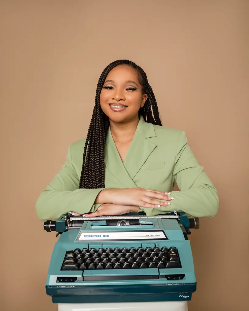 Alexis McGowan poses with an electric typewriter