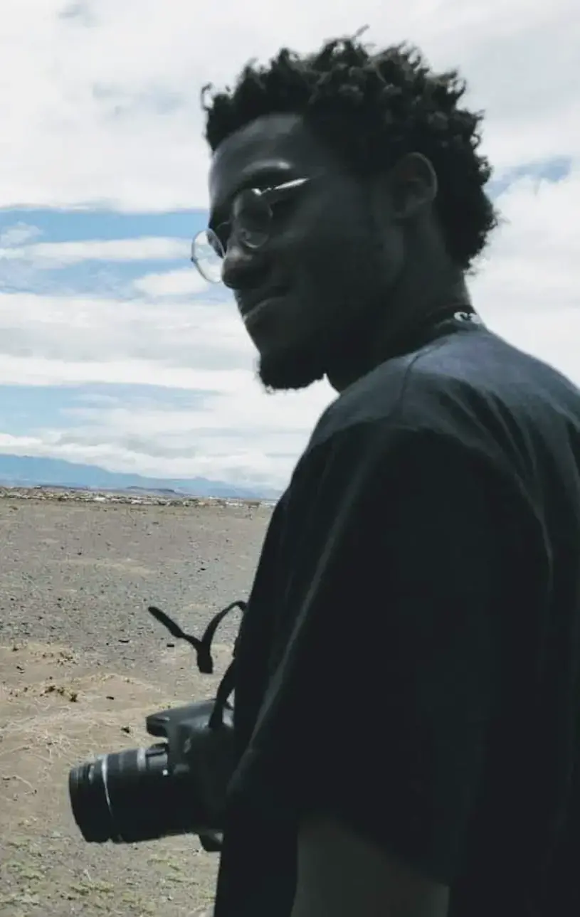 Screen Shot 2022-03-17 at 10.10.24 AM.png Baraka holding camera
