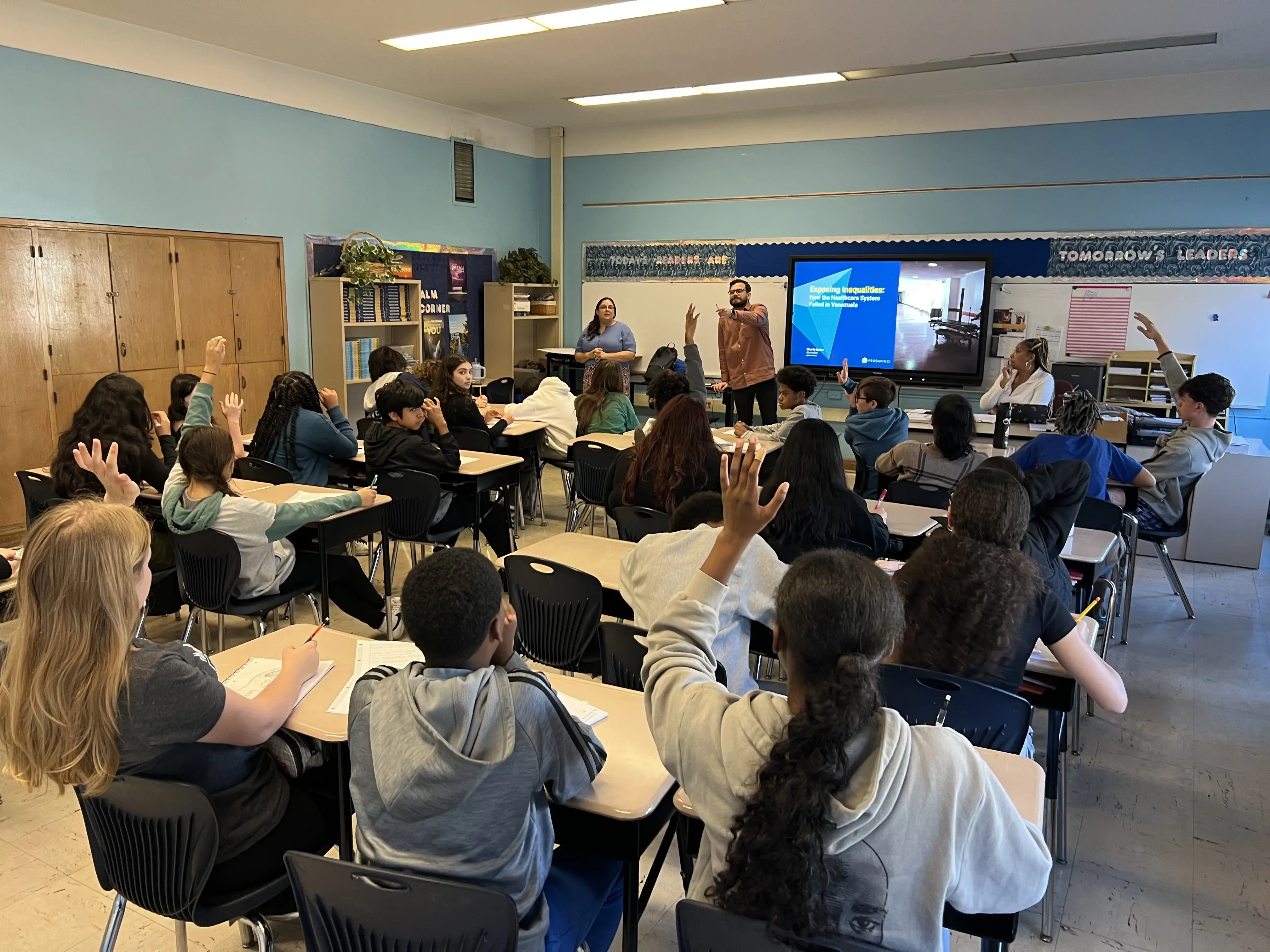 Man calls on student in a classroom.