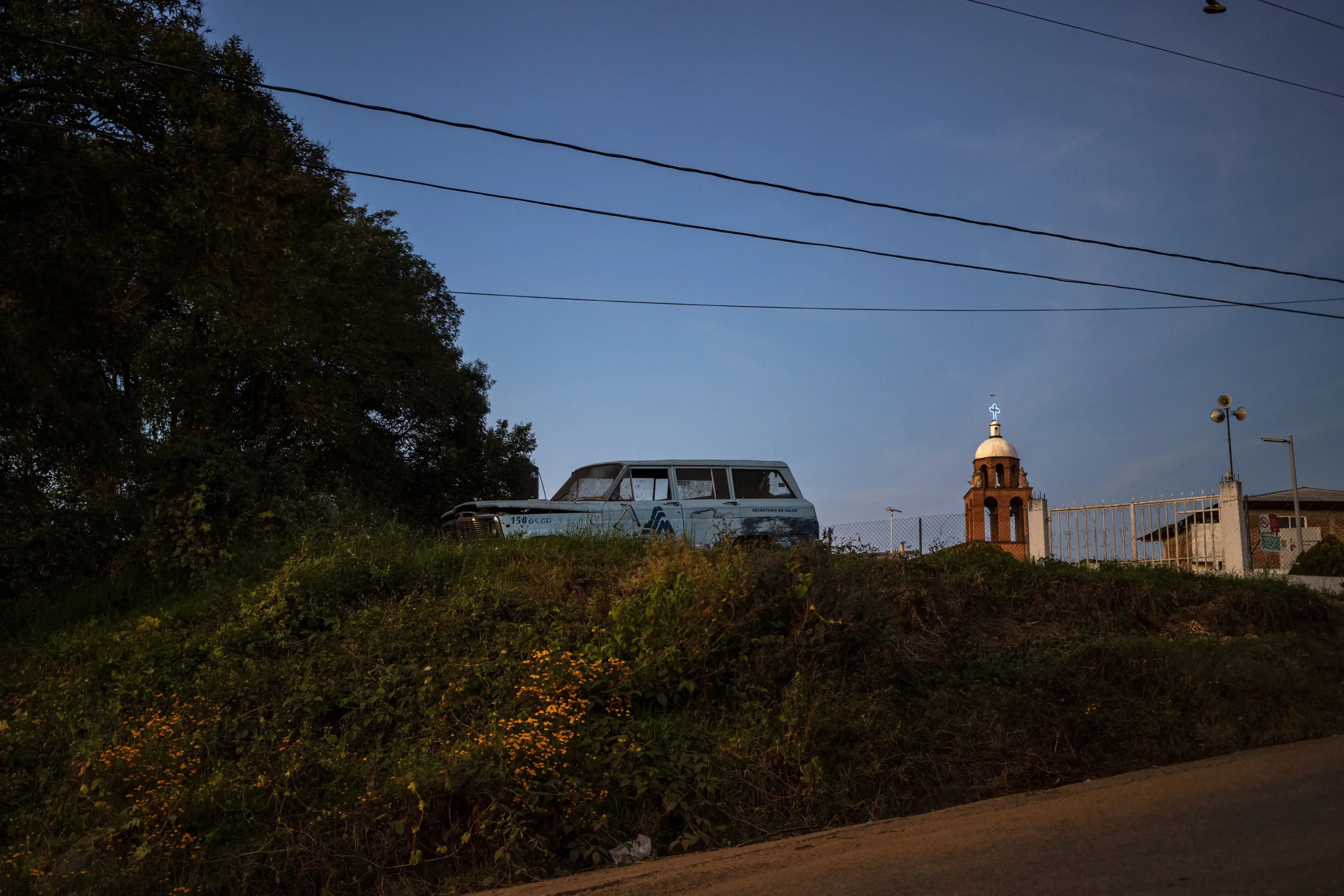 An abandoned truck sits in an empty lot 