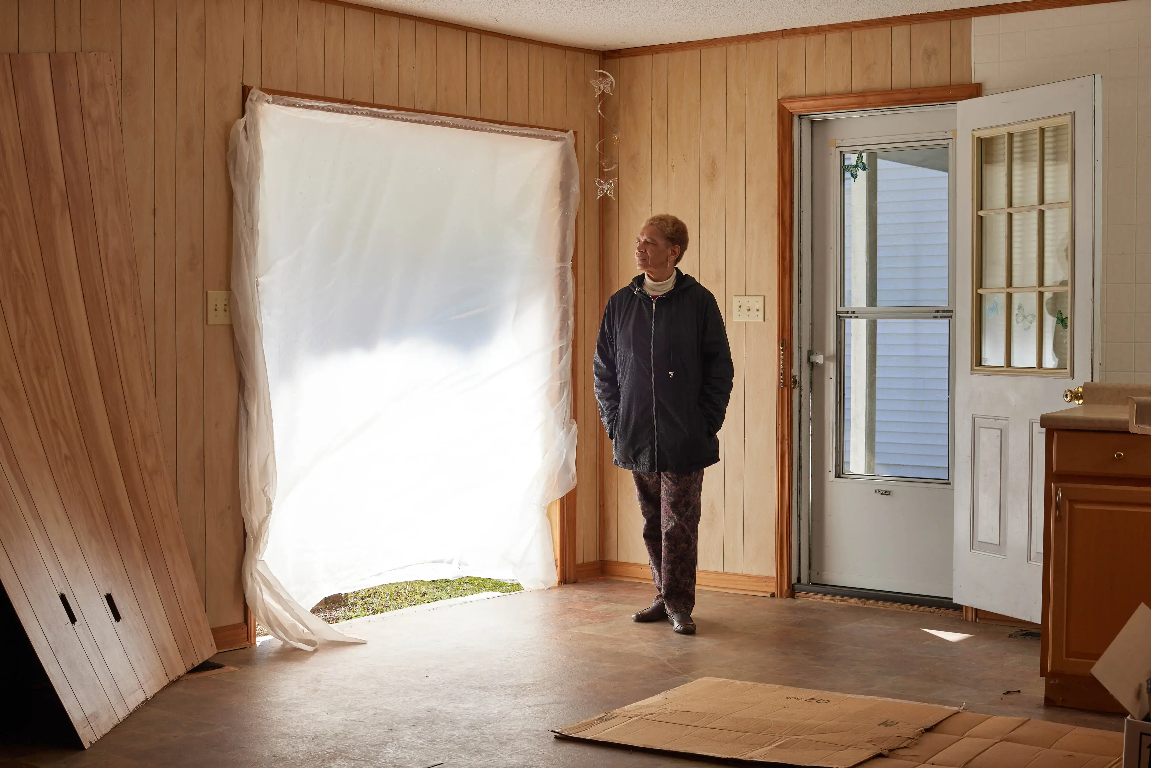 Portrait of Anne Carney at her home in Princeville. Carney opted to have her home torn down and elevated by REBUILD NC a few years after Hurricane Matthew. Instead of having her home bulldozed and its parts go to waste, she let locals come take parts away. Now the home is uninhabitable and the process has been delayed for two years and she is stick paying rent in Tarboro and her mortgage Princeville, North Carolina, Tuesday, March 14, 2023 (Justin Cook)