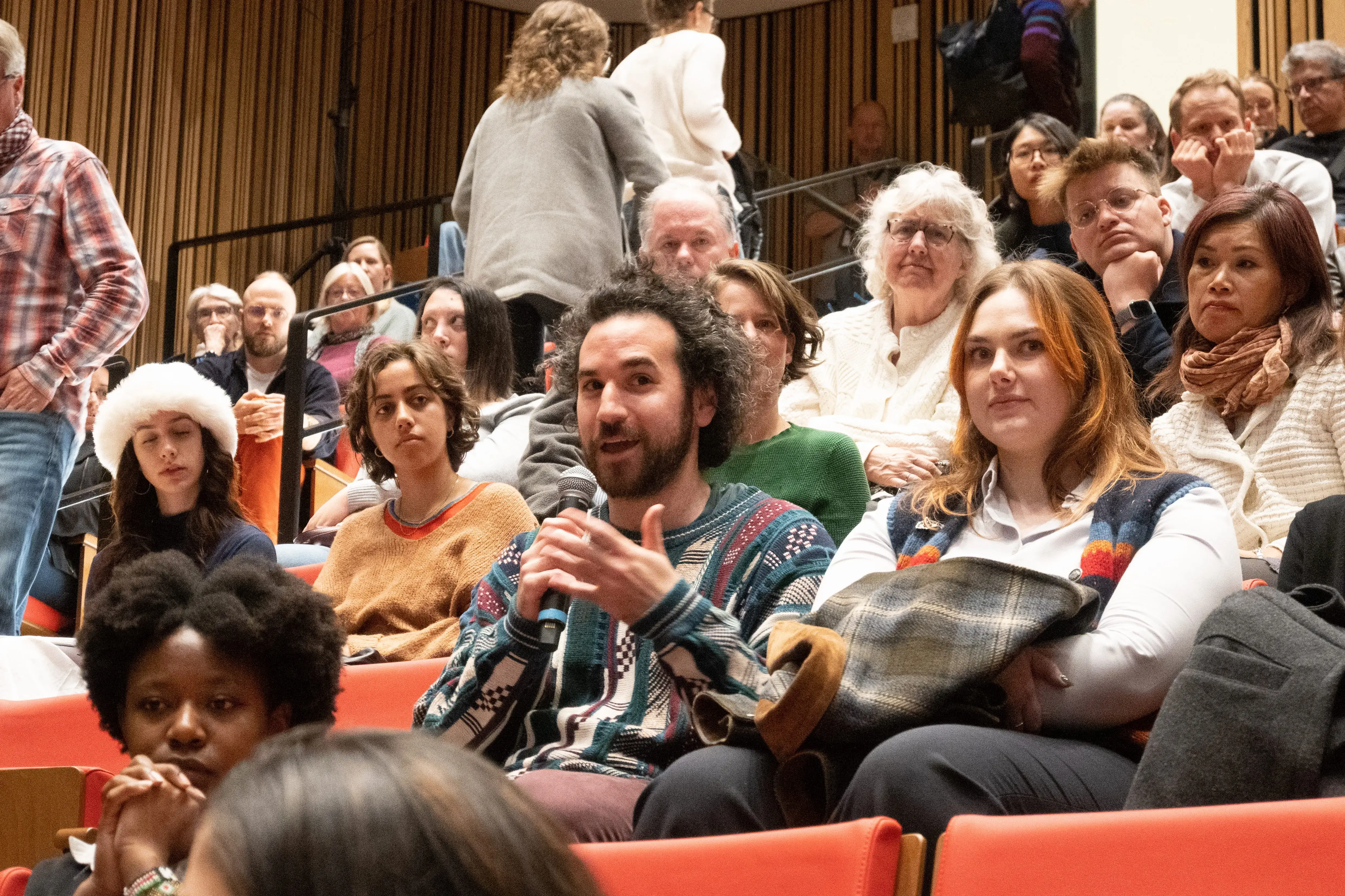 An audience member asks a question