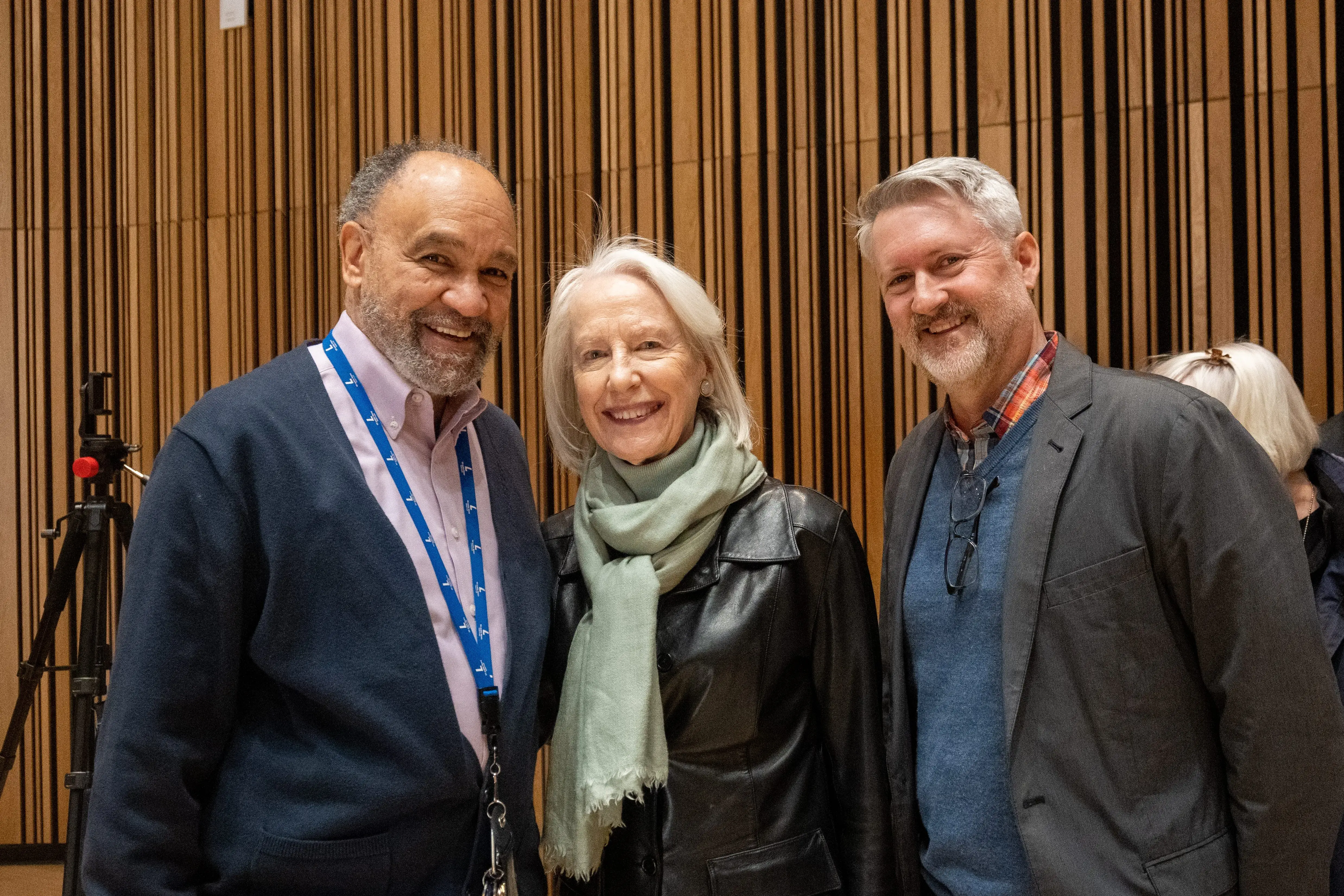 Three attendees pose for a photo