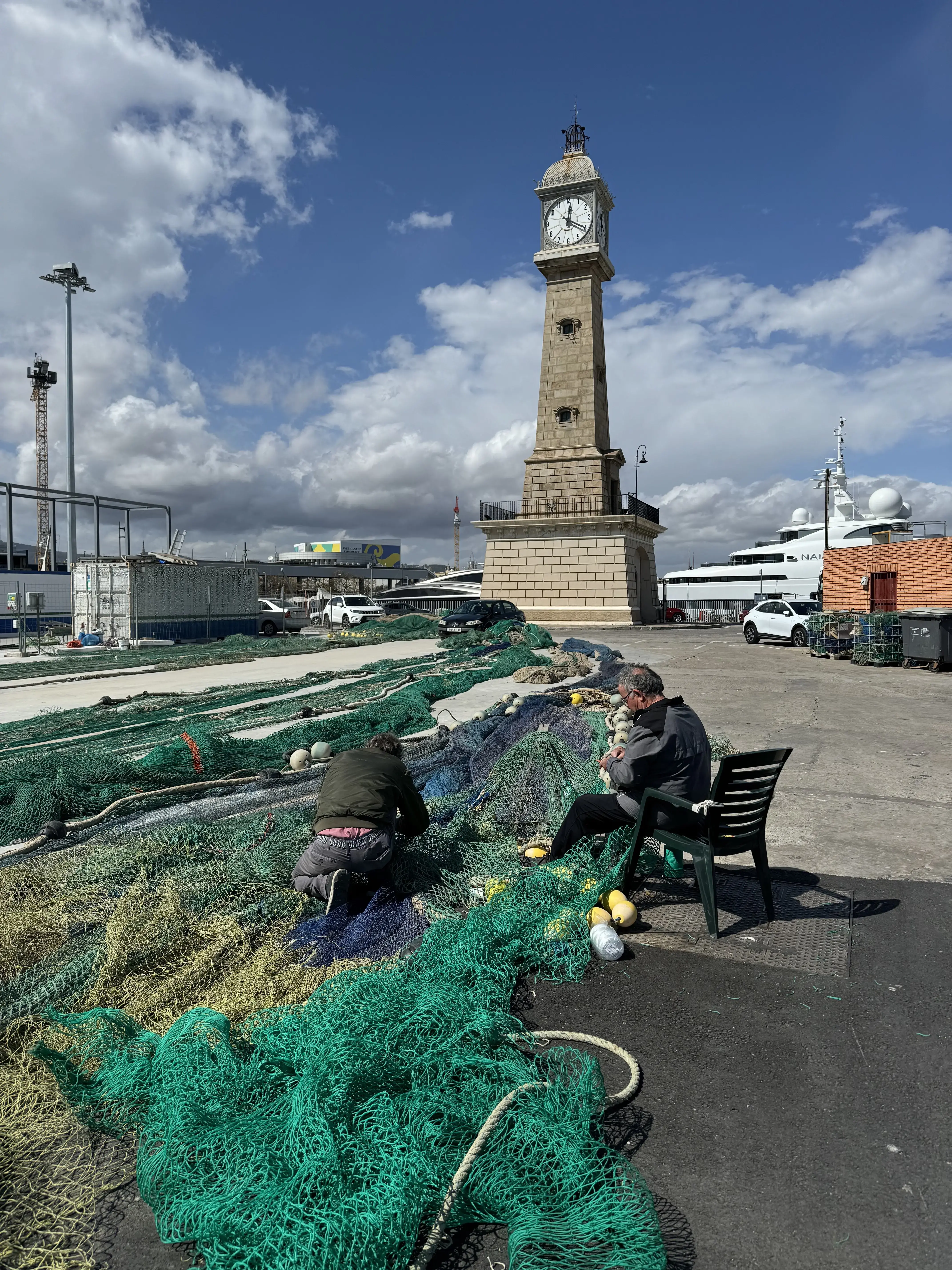 Fishnets at a port with a tall structure in the background